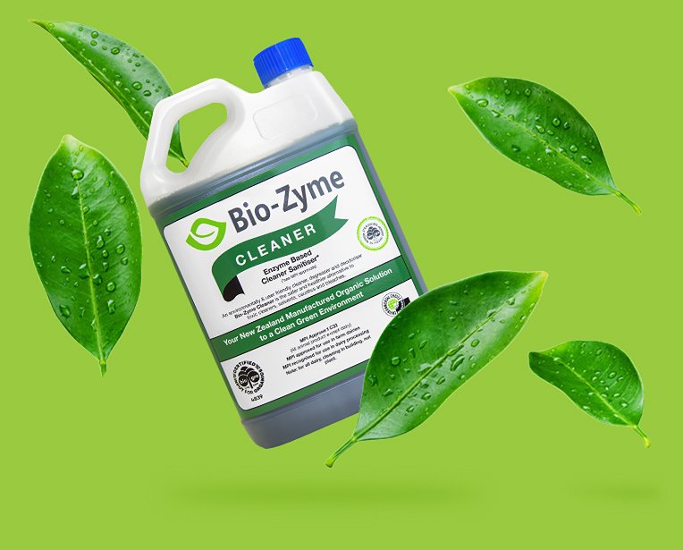 A bottle of Bio-Zyme Cleaner, floating amongst several dew-dotted leaves